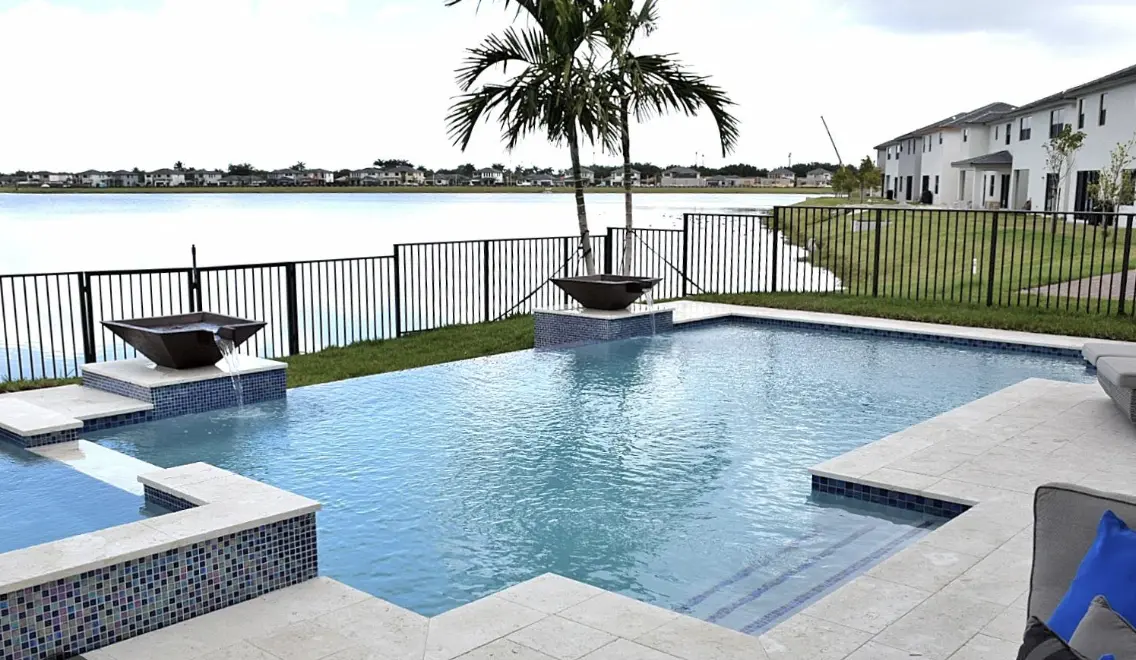 Pool with water features beside a lake